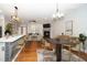 Open-concept living room and kitchen with hardwood floors and fireplace at 520 Camden Yards Way, Cary, NC 27519
