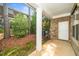 Covered patio with brick wall, white door, and green foliage at 520 Camden Yards Way, Cary, NC 27519