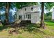 Spacious backyard with lush lawn, mature trees, and a two-story house in the background at 5236 Turf Grass Ct, Raleigh, NC 27610