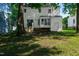 Backyard featuring a well-maintained lawn, shade trees, and a view of the house with a small deck at 5236 Turf Grass Ct, Raleigh, NC 27610