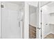 Modern bathroom boasts a walk-in shower with glass doors and a view into the walk in closet at 5236 Turf Grass Ct, Raleigh, NC 27610