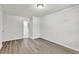 A bright bedroom with light wood floors and doorway view of bathroom at 5236 Turf Grass Ct, Raleigh, NC 27610