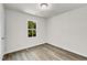 Cozy bedroom featuring a window with natural light and modern flooring at 5236 Turf Grass Ct, Raleigh, NC 27610