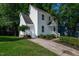 Lovely two-story home featuring a classic white exterior, front porch, and mature trees at 5236 Turf Grass Ct, Raleigh, NC 27610