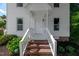 Inviting front entrance with brick steps and classic white railings leading to the front door at 5236 Turf Grass Ct, Raleigh, NC 27610