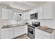 This updated kitchen includes stainless appliances and granite countertops at 5236 Turf Grass Ct, Raleigh, NC 27610