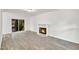 Bright living room featuring wood-look floors, fireplace, and sliding glass doors to the backyard at 5236 Turf Grass Ct, Raleigh, NC 27610