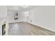 Bright living room featuring wood-look floors, fireplace, and a view of the front yard at 5236 Turf Grass Ct, Raleigh, NC 27610