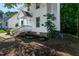 Side view of a well-maintained home with white siding and landscaped garden beds at 5236 Turf Grass Ct, Raleigh, NC 27610