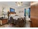 Bright bedroom with a ceiling fan, large windows, and a cozy queen-size bed at 586 New Hope Church Rd, Apex, NC 27523