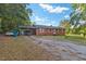 Exterior view of a brick home with a carport and gravel driveway at 586 New Hope Church Rd, Apex, NC 27523
