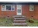 Front entrance of a brick home with a white door and a small brick porch at 586 New Hope Church Rd, Apex, NC 27523