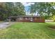 Charming single-story brick home with a spacious front yard, mature trees, and a convenient carport at 586 New Hope Church Rd, Apex, NC 27523