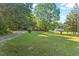 Quaint home featuring a large front yard with mature trees and driveway offering ample parking space at 586 New Hope Church Rd, Apex, NC 27523