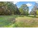 View of a home situated on a spacious lot with mature trees, providing a serene and private setting at 586 New Hope Church Rd, Apex, NC 27523