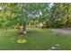 Expansive front yard with mature trees offering ample space and natural beauty, enhancing curb appeal at 586 New Hope Church Rd, Apex, NC 27523