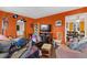 Living room with orange walls and an adjacent dining area, some clutter throughout at 586 New Hope Church Rd, Apex, NC 27523