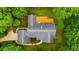 Aerial view showcases the well-maintained roof and large wooden deck surrounded by lush greenery at 5939 Florasaline Dr, Mebane, NC 27302