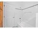 Bright bathroom features a tub-shower combo, decorative tile border, and handy built-in storage at 5939 Florasaline Dr, Mebane, NC 27302