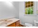 Bathroom featuring a wood vanity, neutral countertop, and a large window with a view of the outdoors at 5939 Florasaline Dr, Mebane, NC 27302