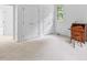 Spacious bedroom with neutral carpet, closet doors, and a window for natural light at 5939 Florasaline Dr, Mebane, NC 27302