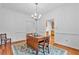 Dining room with hardwood floors, a chandelier, and views into other living spaces at 5939 Florasaline Dr, Mebane, NC 27302