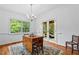 Dining area showcases hardwood floors, a chandelier, and access to a screened-in porch at 5939 Florasaline Dr, Mebane, NC 27302