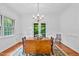 Bright dining room featuring hardwood floors, chandelier, and access to the screen porch at 5939 Florasaline Dr, Mebane, NC 27302