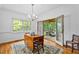 Dining area showcases hardwood floors, a chandelier, and access to a screened-in porch at 5939 Florasaline Dr, Mebane, NC 27302