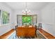 Bright dining room featuring hardwood floors, chandelier, and access to the screen porch at 5939 Florasaline Dr, Mebane, NC 27302