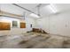 Spacious garage featuring an overhead door, concrete floor, and utility hookups at 5939 Florasaline Dr, Mebane, NC 27302