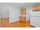 Kitchen area with hardwood floors, wooden cabinets, and access to other rooms of the home at 5939 Florasaline Dr, Mebane, NC 27302