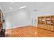Living room featuring hardwood floors, built-in shelving, and a ceiling fan at 5939 Florasaline Dr, Mebane, NC 27302