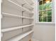 This pantry boasts ample shelving space and a window for natural light at 5939 Florasaline Dr, Mebane, NC 27302