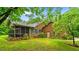 Brick home with a screened porch, green shutters, and lush lawn in a peaceful setting at 5939 Florasaline Dr, Mebane, NC 27302