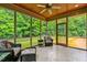 Relaxing screened porch with a ceiling fan and views of the lush green landscape at 5939 Florasaline Dr, Mebane, NC 27302