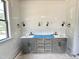 Bathroom features a double sink vanity with shaker cabinets and modern fixtures at 6501 Burnette Flower Way, Raleigh, NC 27612