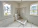 New bathroom features a tile shower and natural light from two windows at 6501 Burnette Flower Way, Raleigh, NC 27612