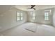 Spacious bedroom with a ceiling fan and multiple windows, providing ample natural light at 6501 Burnette Flower Way, Raleigh, NC 27612