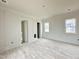 A spacious bedroom features neutral walls, natural wood floors, paneled accents, and plenty of natural light at 6501 Burnette Flower Way, Raleigh, NC 27612