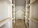 Walk-in closet has extensive shelving with lots of storage space and a central dressing bench at 6501 Burnette Flower Way, Raleigh, NC 27612