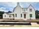 A charming, two-story home boasts a neutral exterior, inviting entrance, and attached side structure, perfect for modern living at 6501 Burnette Flower Way, Raleigh, NC 27612