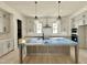 Bright, spacious kitchen featuring a central island, stainless steel appliances and shaker cabinets at 6501 Burnette Flower Way, Raleigh, NC 27612
