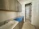 Laundry room features a sink, granite countertop, and ample cabinet space at 6501 Burnette Flower Way, Raleigh, NC 27612