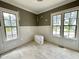 Bright living room featuring newly installed hardwood floors, wainscoting, and large windows at 6501 Burnette Flower Way, Raleigh, NC 27612