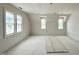 Room with natural light from three windows and smooth walls at 6501 Burnette Flower Way, Raleigh, NC 27612
