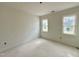 Room with natural light from two windows and smooth walls at 6501 Burnette Flower Way, Raleigh, NC 27612