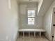 Cozy storage area with custom built-in shelving beneath a window at 6501 Burnette Flower Way, Raleigh, NC 27612