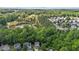 Aerial view of a neighborhood, forest, and a pond at 6604 Frogstool Ln, Raleigh, NC 27610