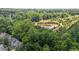 Picture of trees and a pond and the roof of a building at 6604 Frogstool Ln, Raleigh, NC 27610